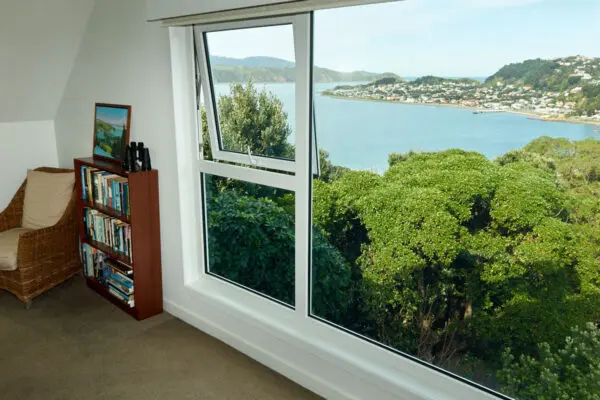 Open awning window with view of city and sea