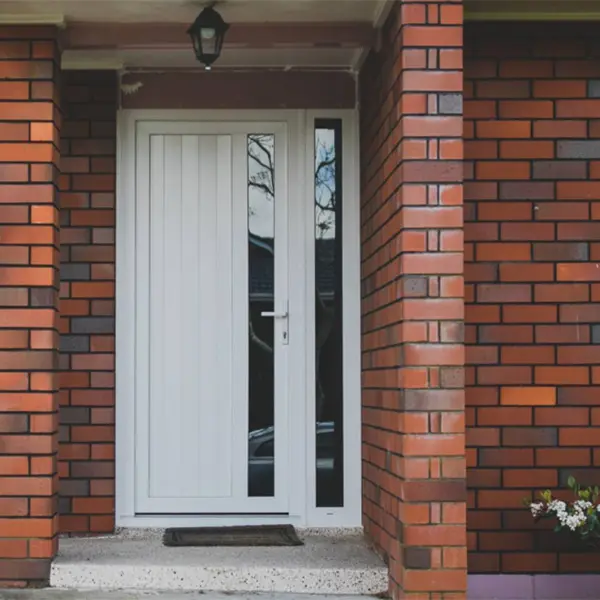 White entrance door on brick home