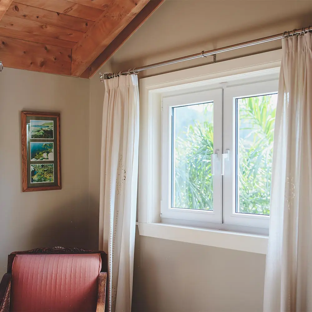 White uPVC window in cozy bedroom